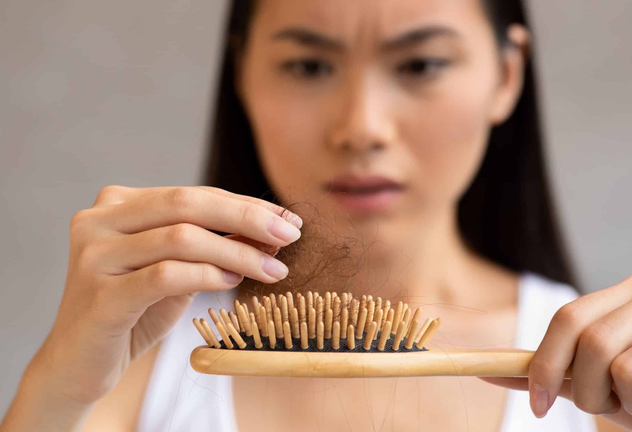 A woman notices the first signs of hair loss
