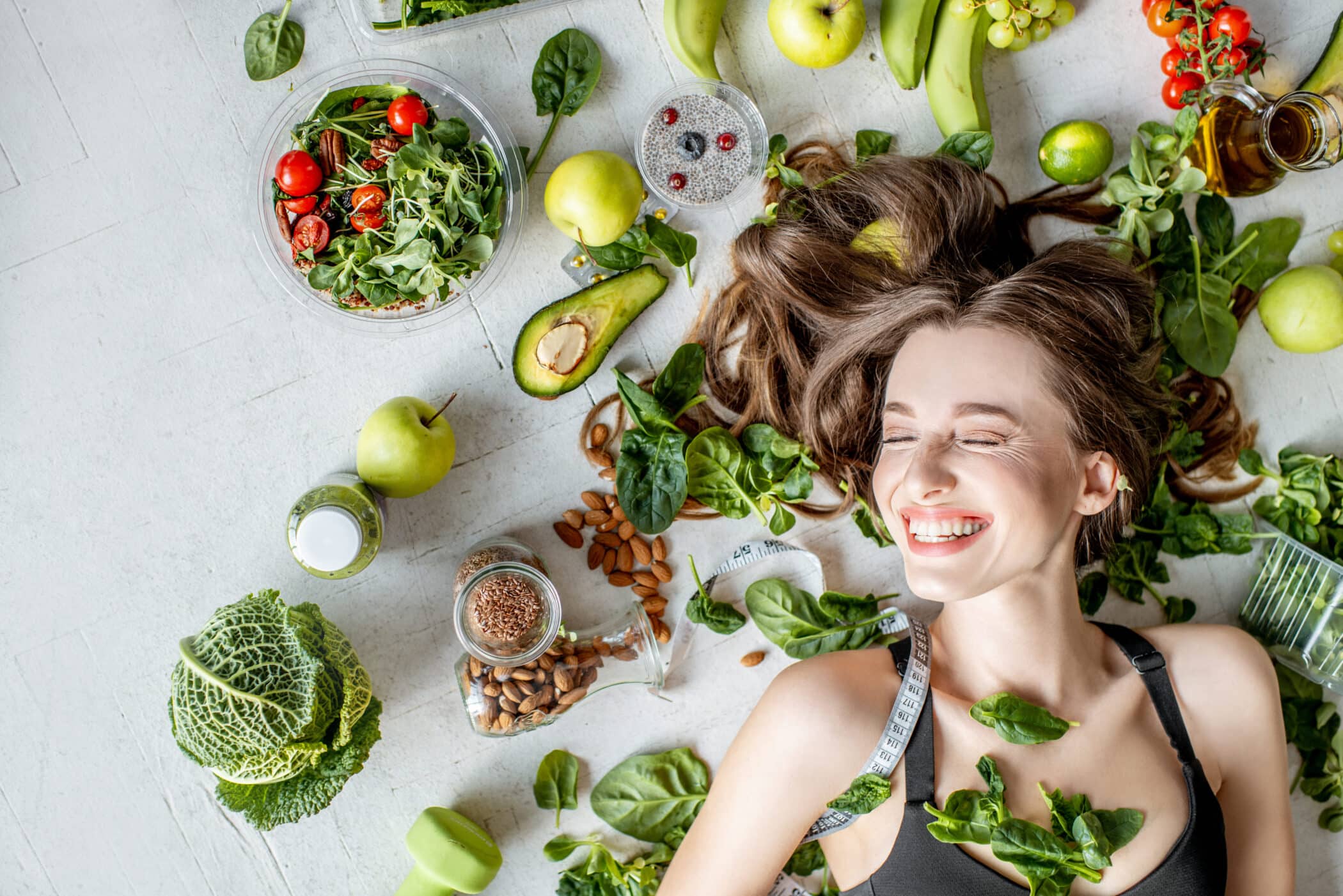 A woman surrounded by foods that promote hair health