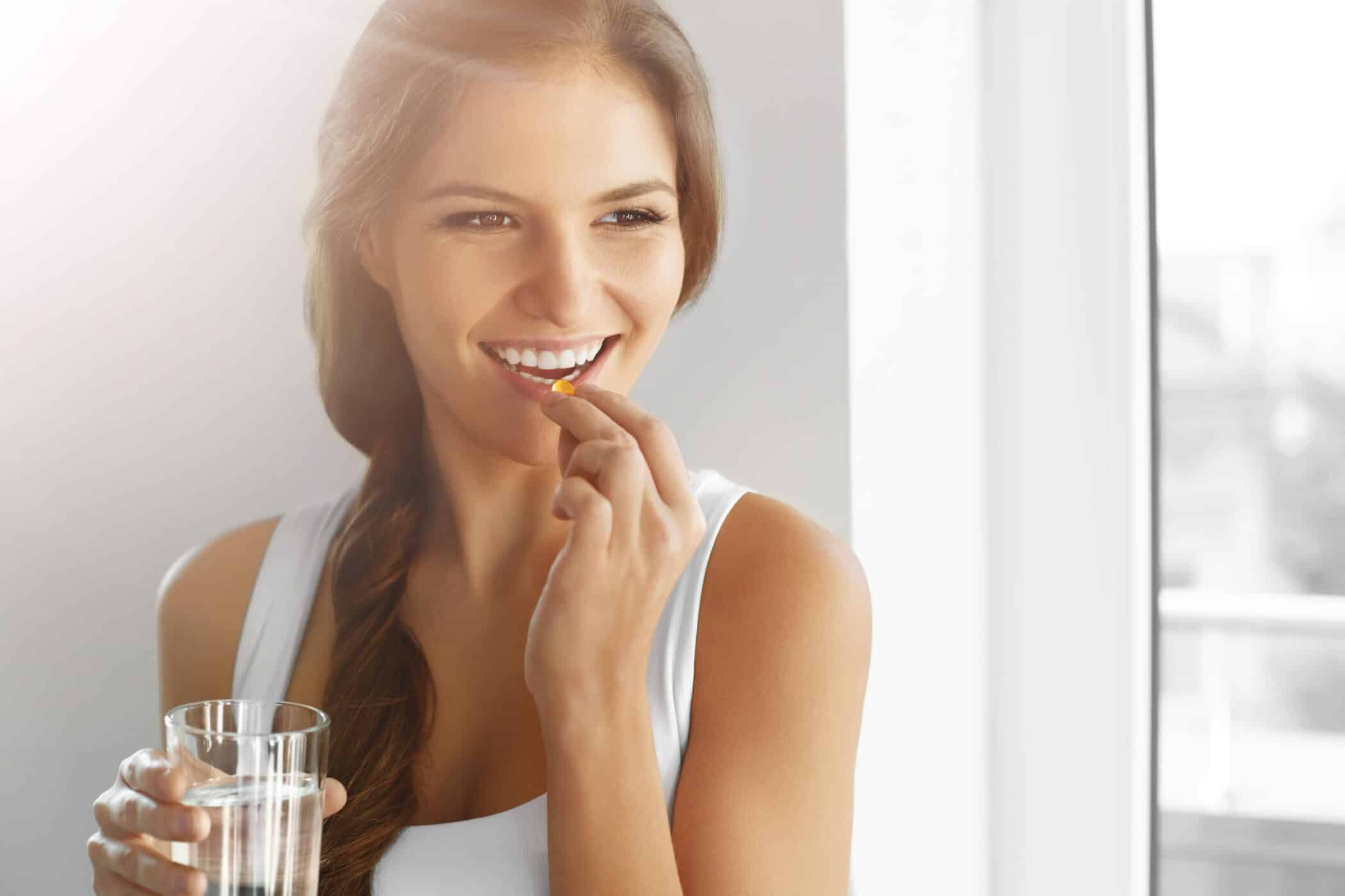 A woman taking a supplement