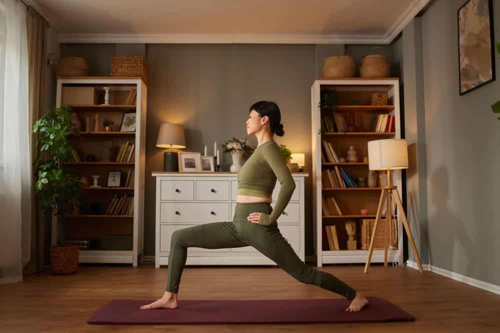 Woman doing yoga at home, a safe option to consider when you can work out after a hair transplant