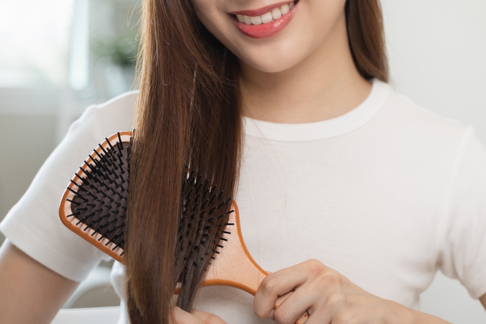 Woman with healthy, strong hair supported by adequate biotin for hair health